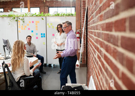 Creative Team Meeting To Discuss Ideas In Modern Office Stock Photo
