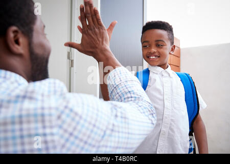 Father Giving Son High Five As He Leaves For School Stock Photo