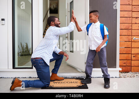 Father Giving Son High Five As He Leaves For School Stock Photo