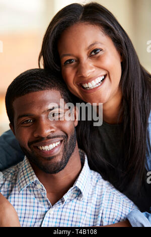 Portrait Of Smiling Loving Couple Hugging At Home Stock Photo