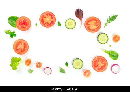 Fresh vegetable salad ingredients, shot from above on a white background. A flat lay composition with tomato, cucumber, onion slices and mezclun Stock Photo