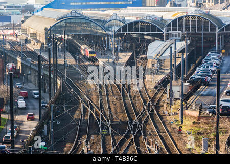 Grand old Newcastle Central railway station and multiple train tracks of the east coast main line and showing an express train at the platform Stock Photo