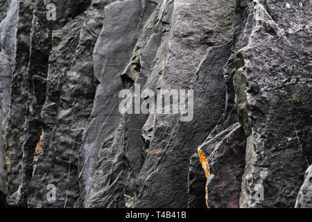 Close up detail shot selective focus of nature of natural dark black slate with gray stone. Construction decoration material background concept. Stock Photo