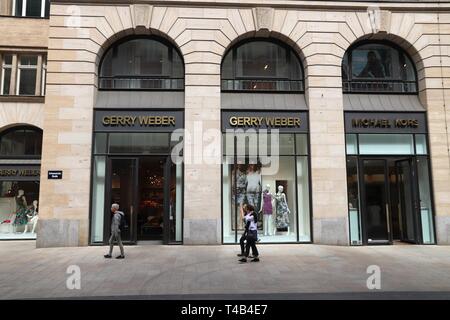 LEIPZIG, GERMANY - MAY 9, 2018: People walk by Gerry Weber and Michael Kors at Grimmaische Street in Leipzig, Germany. Grimmaische Strasse is the hear Stock Photo