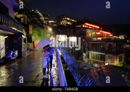 JIUFEN, TAIWAN - NOVEMBER 23, 2018: People visit rainy heritage Old Town of Jiufen located in Ruifang District of New Taipei City. Jiufen is also know Stock Photo