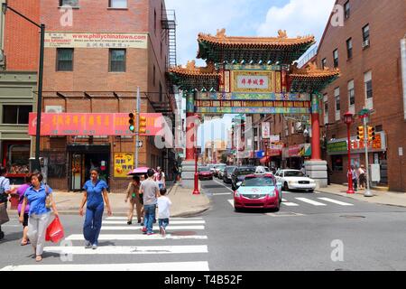 PHILADELPHIA, USA - JUNE 11, 2013: People visit Chinatown in Philadelphia. The Chinatown gate was completed in 1984 and represents partnership with si Stock Photo