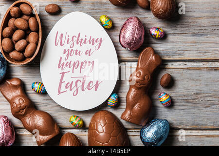 Chocolate easter eggs and bunnies on a rustic wooden background Stock Photo