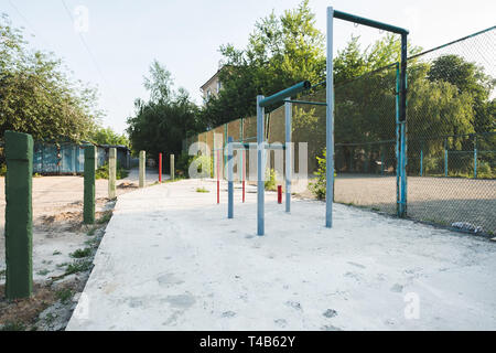 children's playground with swings in courtyard of residential building in the city, Kiev, Ukraine Stock Photo