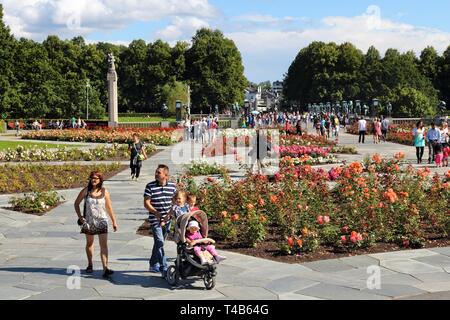 OSLO, NORWAY - AUGUST 2, 2015: People visit gardens and Vigeland Installation in Frogner Park, Oslo. 212 sculptures around the park were all designed  Stock Photo