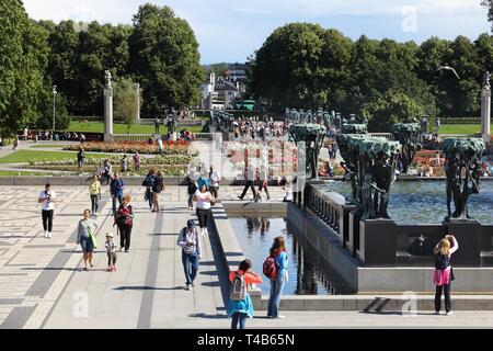 OSLO, NORWAY - AUGUST 2, 2015: People visit gardens and Vigeland Installation in Frogner Park, Oslo. 212 sculptures around the park were all designed  Stock Photo