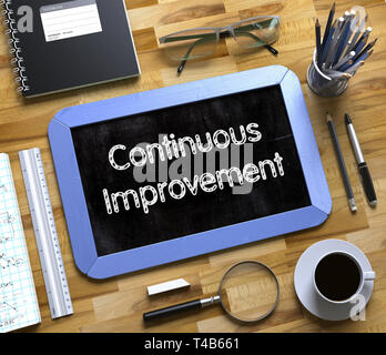 Continuous Improvement - Text on Small Chalkboard. 3D Rendering. Stock Photo