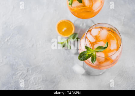 Classic Italian aperol spritz cocktail in wine glass on light. Close up. Stock Photo