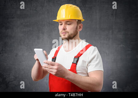 Construction worker using smartphone Stock Photo