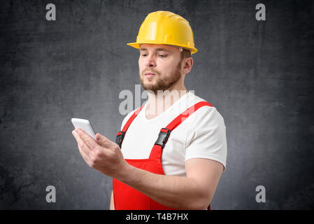 Construction worker using smartphone Stock Photo