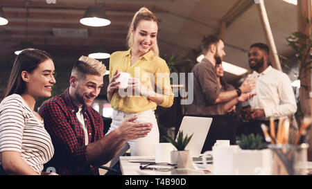 Business professionals. Young people analyzing data on laptop Stock Photo