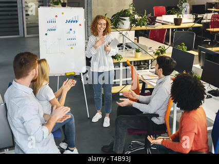 Woman team leader making presentation for colleagues Stock Photo