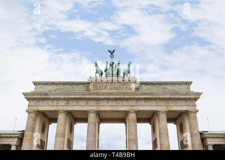 Famous neoclassical Brandenburg Gate (Brandenburger Tor) in Berlin, Germany, on a cloudy day. Copy space.