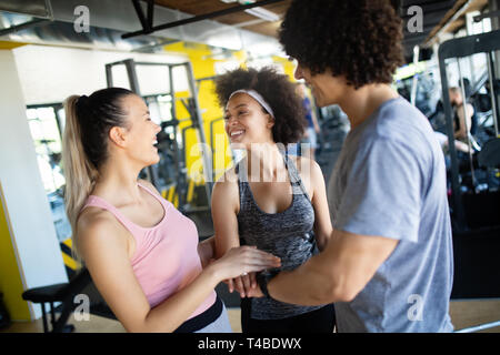 Happy gorup of healthy people training in gym Stock Photo