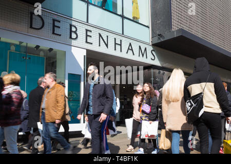 Shoppers walk past the Debenhams flagship store in Oxford Street, London, UK Stock Photo