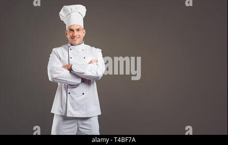 Chef in white uniform is smiling. Stock Photo