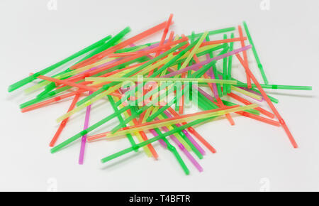 Pile of plastic straws scattered against a white background Stock Photo
