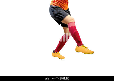 Football player woman in orange jersey kick the ball posing isolated over white background Stock Photo