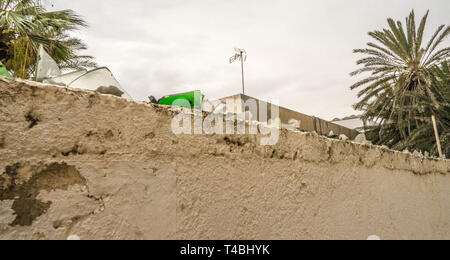 Broken glass on the top of the wall Stock Photo
