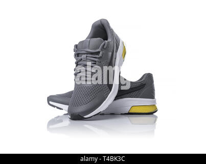 Unbranded black sport running shoes or sneakers isolated on white background. Stock Photo