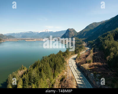 Aerial view of Sea to Sky Highway with Chief Mountain in the background during a sunny day. Taken near Squamish, North of Vancouver, British Columbia, Stock Photo