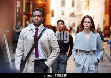 Millennial business people walking in a London street, front view, close up Stock Photo