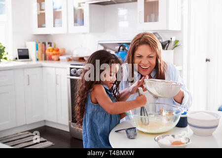 Young Hispanic Girl Holding Middle Avocado Smiling With An Idea Or 