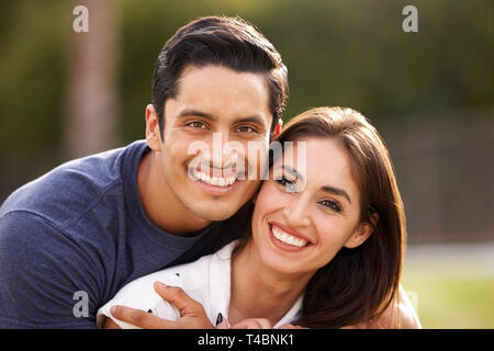 Young Hispanic couple looking to camera smiling, close up Stock Photo