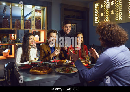 Happy friends having dinner in the restaurant Stock Photo