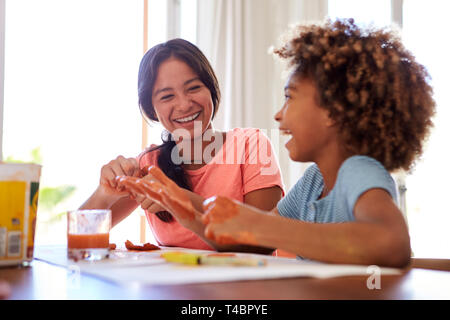 Close up of two girlfriends having fun playing with modelling clay at home, close up, selective focus Stock Photo