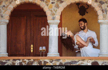 Romantic couple on a date dancing together. Couple spending time together dancing on a wine date. Stock Photo