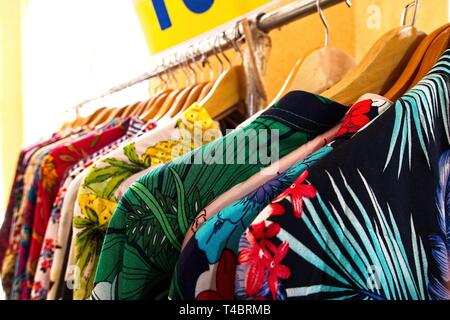Choice of fashion clothes of different colors on wooden hangers Stock Photo