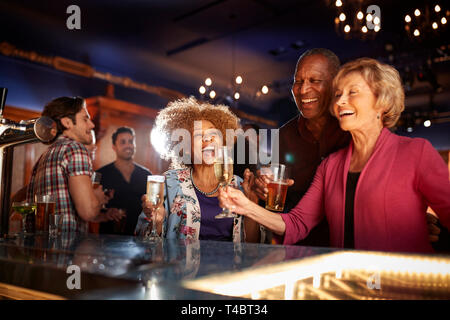 Group Of Senior Friends Drinking In Bar Together Stock Photo