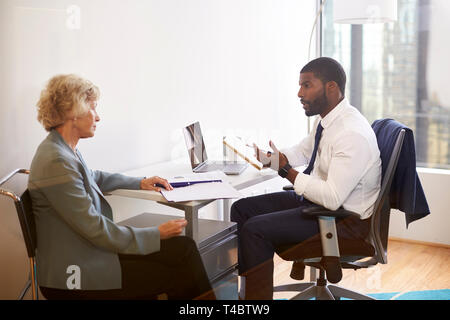 Senior Woman Meetings With Male Doctor Financial Advisor Cosmetic Surgeon In Office Stock Photo