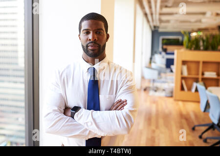 Portrait Of Businessman Wearing Smart Watch In Modern Office Standing By Window Stock Photo