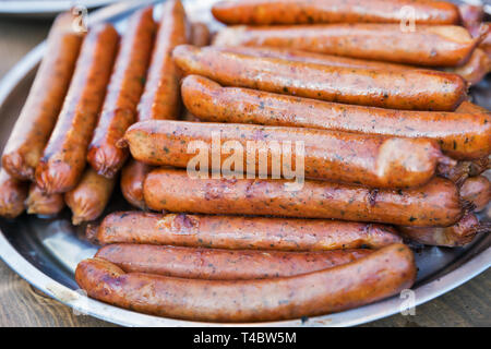 Street fast food grilled sausages closeup on a dish Stock Photo