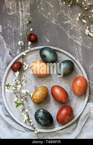 Easter eggs dyed with natural dyes, cabbage, chamomile, hibiscus and onion peel. Selective focus. Stock Photo