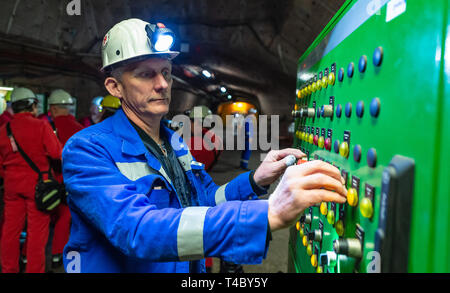 Gorleben, Germany. 15th Apr, 2019. A miner controls an elevator underground in the former exploration mine. After decades of dispute over a repository for highly radioactive nuclear waste in Gorleben, the exploration area of the mine has been almost completely dismantled. During a symbolic final inspection of the salt dome it was now shown what the so-called open-keeping operation looks like. Credit: Philipp Schulze/dpa/Alamy Live News Stock Photo