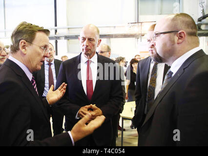 15 April 2019, Thuringia, Hermsdorf: Bodo Ramelow (Die Linke), Thuringia's Minister President, Wolfgang Tiefensee (SPD), Thuringia's Minister of Economics, Ingolf Voigt and Michael Stelter from the Fraunhofer Institute (l-r) speak together on the occasion of the ground-breaking ceremony for a new center at the Fraunhofer Institute for Ceramic Technologies and Systems. For example, the Institute wants to continue working on new energy storage devices made of ceramics and plastics that last longer and are more powerful than today's batteries and accumulators. Photo: Bodo Schackow/dpa Stock Photo