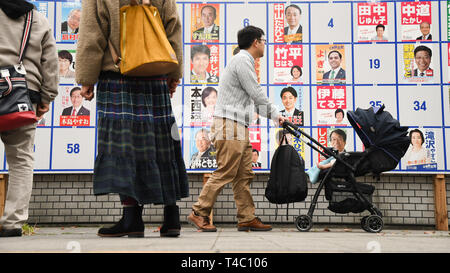 Tokyo, Japan. 14th Apr, 2019. People passes by an Edogawa ward congressional member election advertising board near Kasai Station in Tokyo Japan, voting will take place on April 22, 2019. Photo taken on Sunday, April 15, 2019. Photo: Ramiro Agustin Vargas Tabares Credit: Ramiro Agustin Vargas Tabares/ZUMA Wire/Alamy Live News Stock Photo