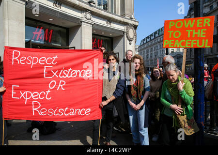 London, UK, UK. 15th Apr, 2019. Environmental activists are seen holding a banner and a placard during the protest.Activist protest at the Parliament Square demanding for urgent Government action on climate change, the protest was organised by Extinction Rebellion. Credit: Dinendra Haria/SOPA Images/ZUMA Wire/Alamy Live News