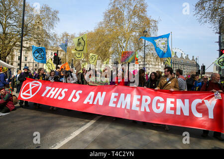 London, UK, UK. 15th Apr, 2019. Environmental activists are seen holding a banner that says this is emergency during the demonstration.Activist protest at the Parliament Square demanding for urgent Government action on climate change, the protest was organised by Extinction Rebellion. Credit: Dinendra Haria/SOPA Images/ZUMA Wire/Alamy Live News