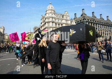 London, UK, UK. 15th Apr, 2019. Environmental activists are seen carrying a coffin during the demonstration.Activist protest at the Parliament Square demanding for urgent Government action on climate change, the protest was organised by Extinction Rebellion. Credit: Dinendra Haria/SOPA Images/ZUMA Wire/Alamy Live News Stock Photo