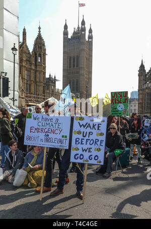 London, UK. 15th Apr, 2019. Protesters seen holding placards during the Extinction Rebellion demonstration in London. Extinction Rebellion protesters bring London to a standstill. The protesters lined up across the exits to Parliament Square in Westminster, with some sitting in the road. The group plan to be blocking five of the city's busiest and most iconic locations in a non-violent, peaceful act of rebellion - for up to two weeks Credit: Keith Mayhew/SOPA Images/ZUMA Wire/Alamy Live News Stock Photo