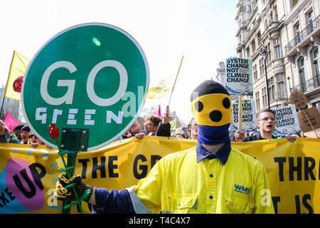 An environmental activist seen holding a placard that says go green during the demonstration at the Parliament Square. Activist protest at the Parliament Square demanding for urgent Government action on climate change, the protest was organised by Extinction Rebellion. Stock Photo