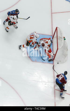 Denver, Colorado, USA. 15th Apr, 2019. Calgary Flames goaltender Mike Smith (41) prepares to make save on shot by Colorado Avalanche right wing Mikko Rantanen (96) as Calgary Flames defenseman Travis Hamonic (24) moves in to defend during the Calgary Flames and Colorado Avalanche NHL playoff game at Pepsi Center in Denver, Colorado. Colorado defeated Calgary 6-2. John Crouch/CSM/Alamy Live News Stock Photo